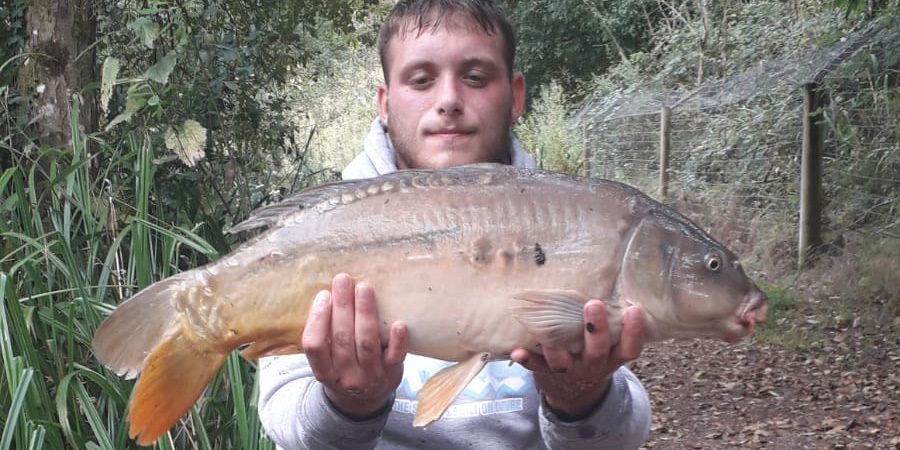 Man holding common carp